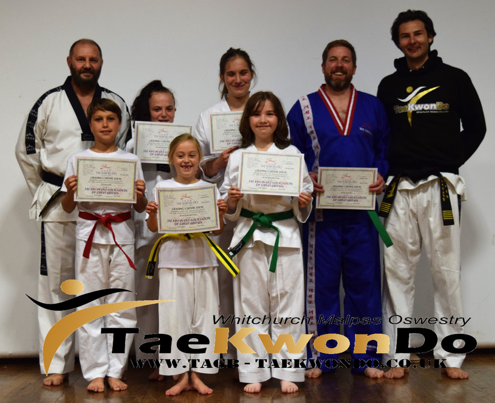 Oswestry Tae Kwon Do students receiving their new belts and certificates from the last colour belt grading.